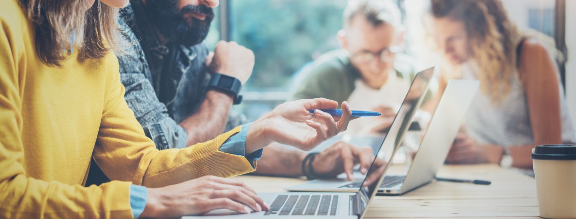 Closeup-Group-Young-Coworkers-Together-Discussing-Creative-Project-During-Work-608505608_4250x2348.j