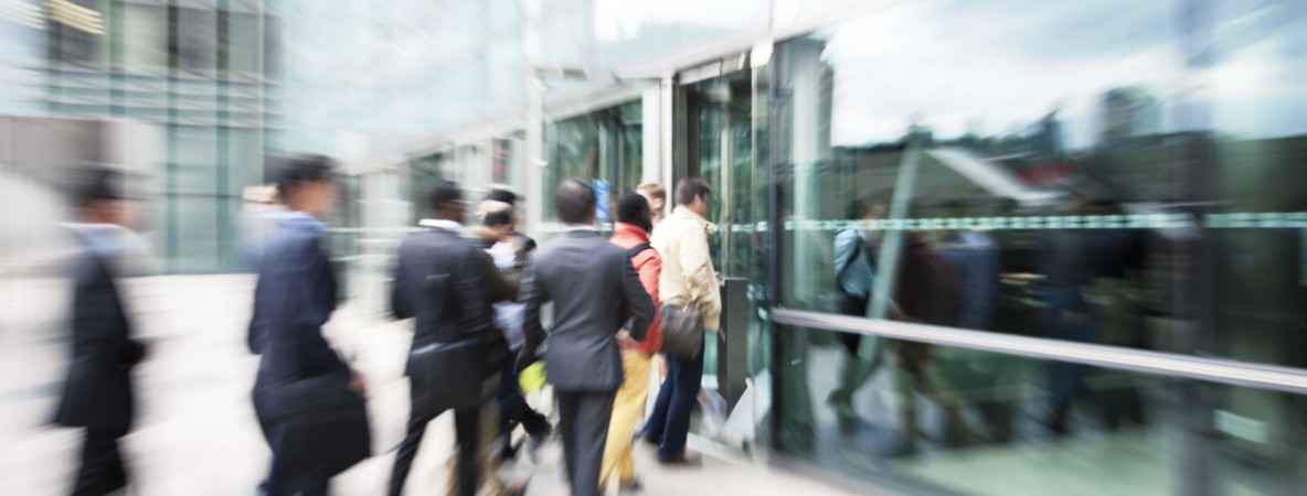 Blurred-Business-People-Entering-Office-Building-Through-Glass-Doors-171583116_2122x1415.jpeg