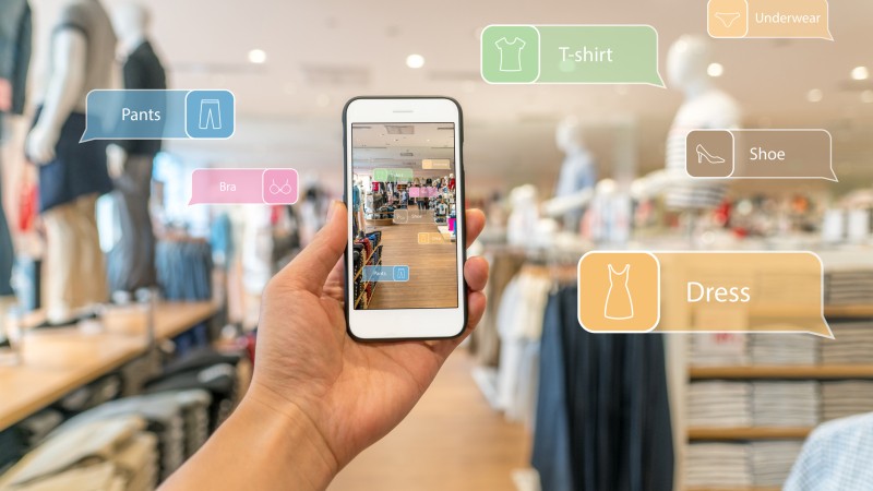Augmented-reality-marketing.-Hand-holding-smart-phone-use-AR-application-to-check-information-658404