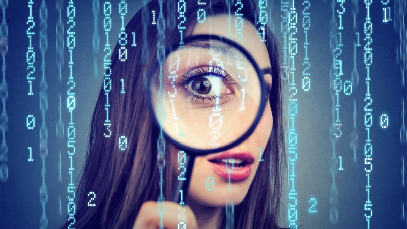 Investigation-surveillance-of-cyber-crime-concept.-Curious-woman-looking-through-a-magnifying-glass-