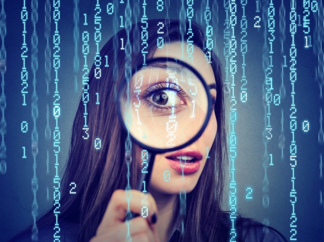 Investigation-surveillance-of-cyber-crime-concept.-Curious-woman-looking-through-a-magnifying-glass-