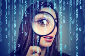 Investigation-surveillance-of-cyber-crime-concept.-Curious-woman-looking-through-a-magnifying-glass-