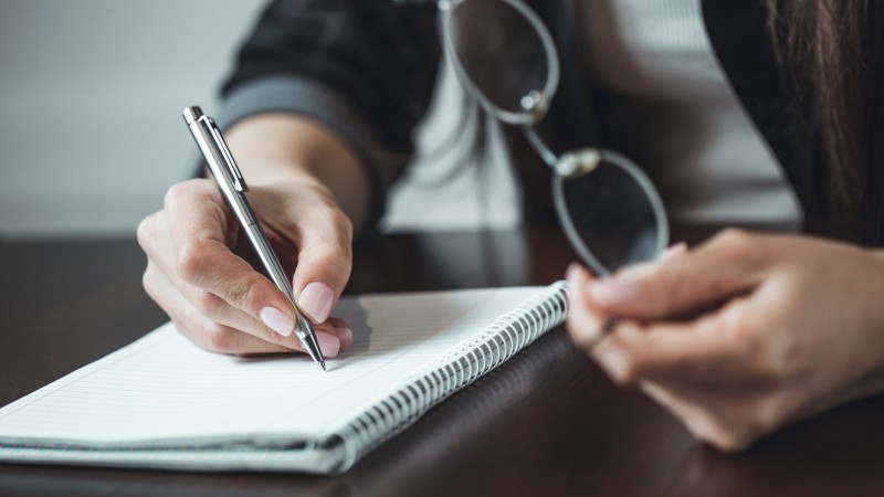 Close-up-shot-of-human-hand-writing-something-on-the-paper.-Shallow-DOF.-Focus-on-pencil-680568334_2