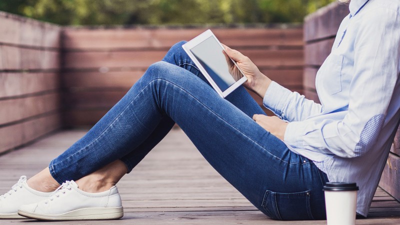 Young-woman-using-digital-tablet-outdoors.jpg