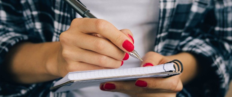 Woman-in-plaid-shirt-and-a-red-manicure-pen-writing-508541368_4898x3265_crop.jpg