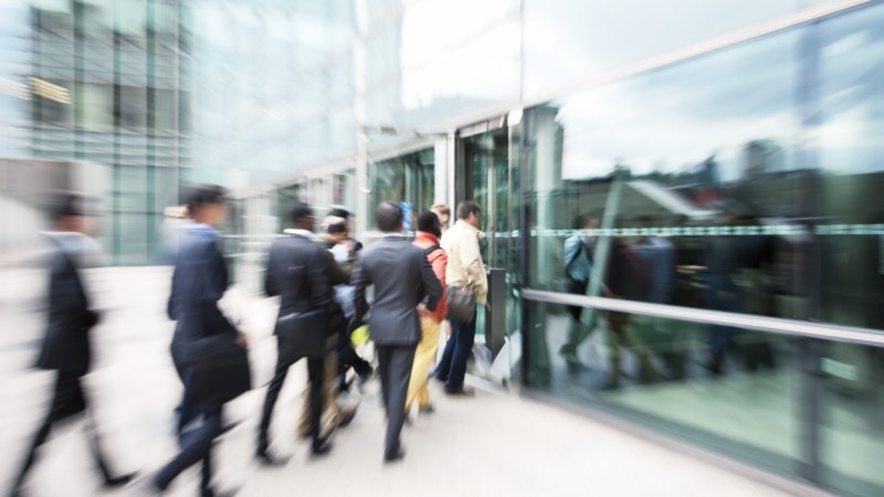 Blurred-Business-People-Entering-Office-Building-Through-Glass-Doors-171583116_2122x1415.jpeg