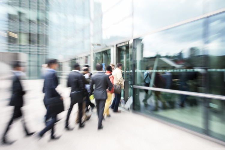 Blurred-Business-People-Entering-Office-Building-Through-Glass-Doors-171583116_2122x1415.jpeg